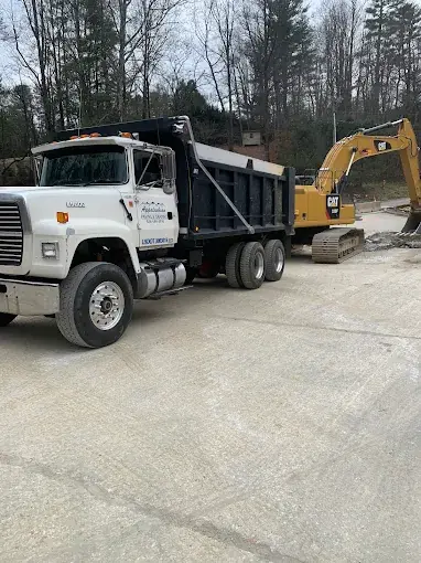 A dump truck and excavator on a job site