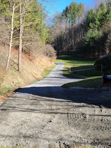 A graded drive heading into the trees