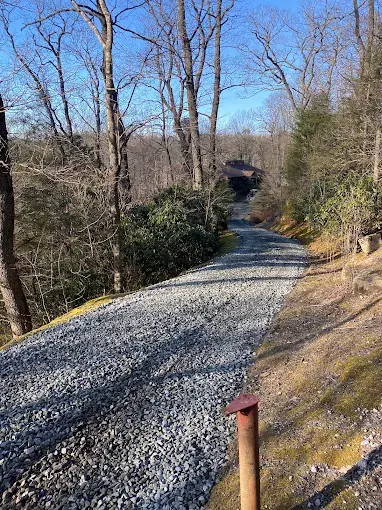 A gravel drive through the woods