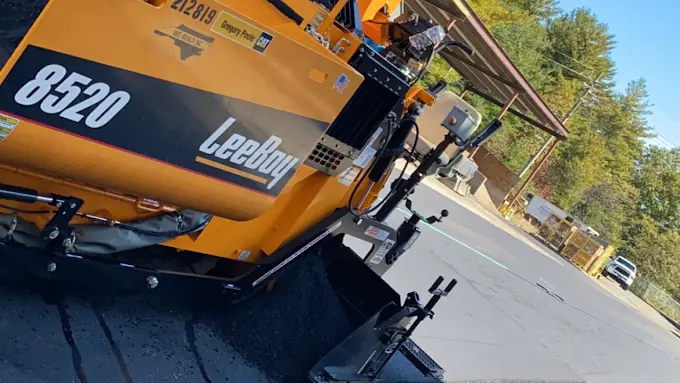 An asphalt paver laying a new surface