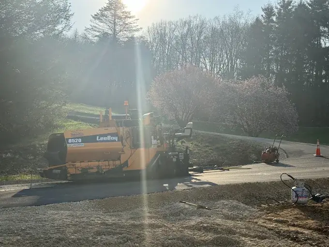 A paver working on a drive in morning light