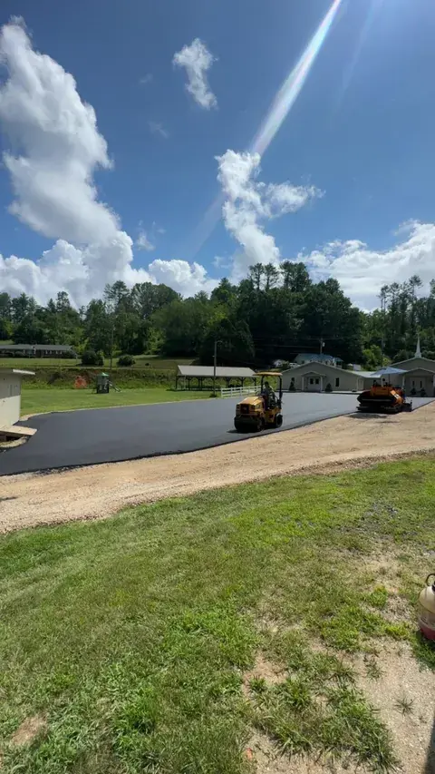 A paver and roller on a new lot